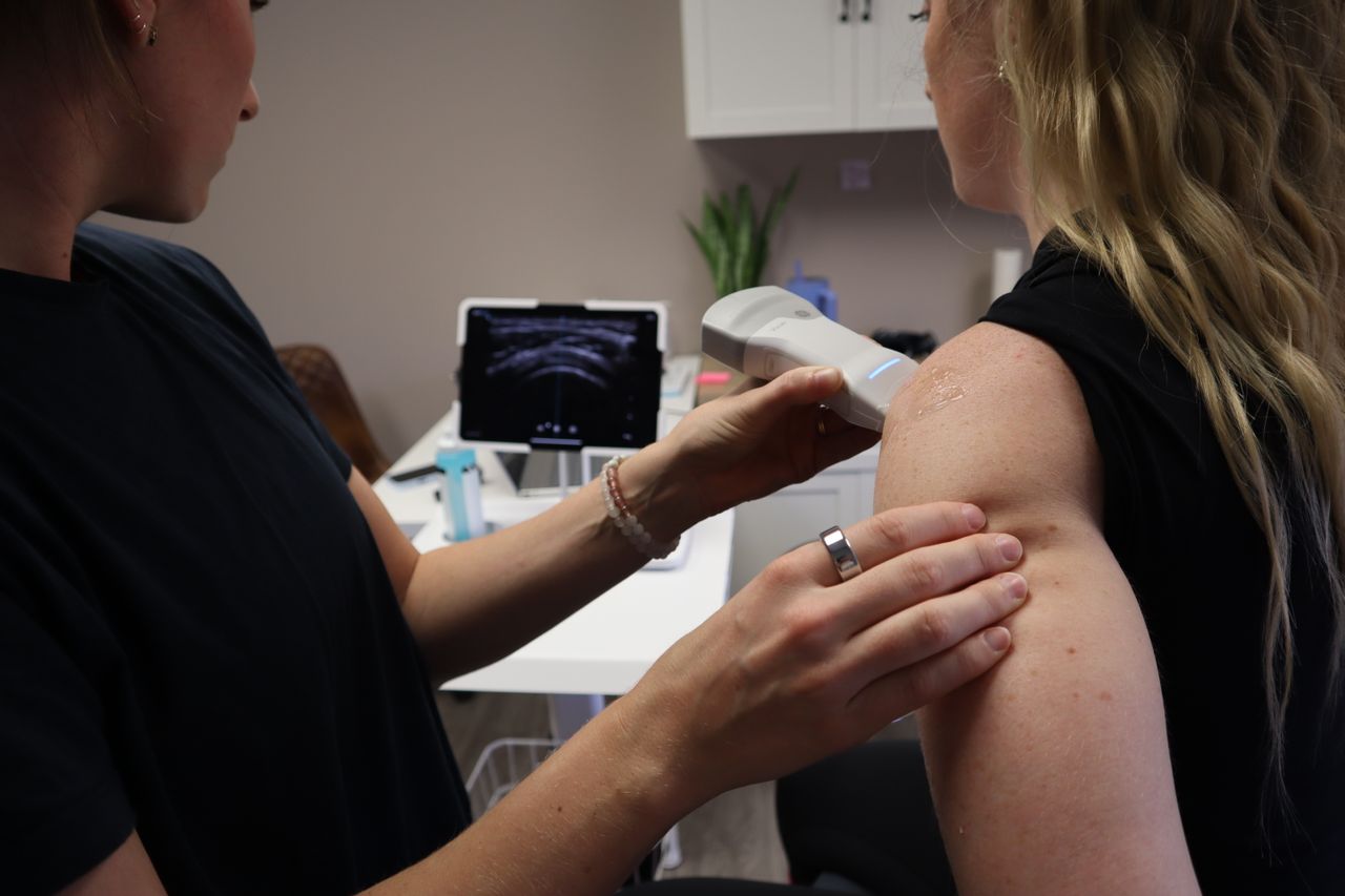 Woman with rotator cuff injury with her doctor