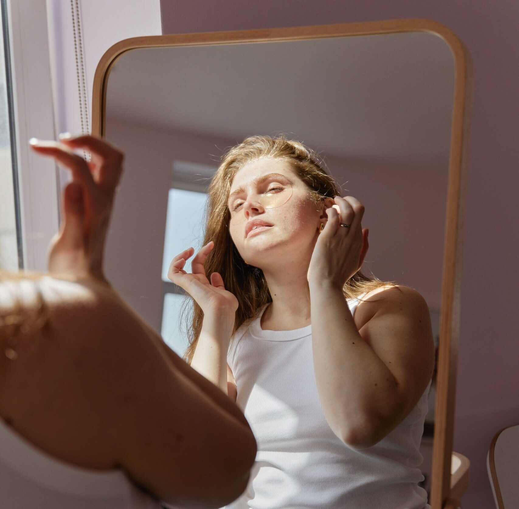 Woman with scar looking in the mirror