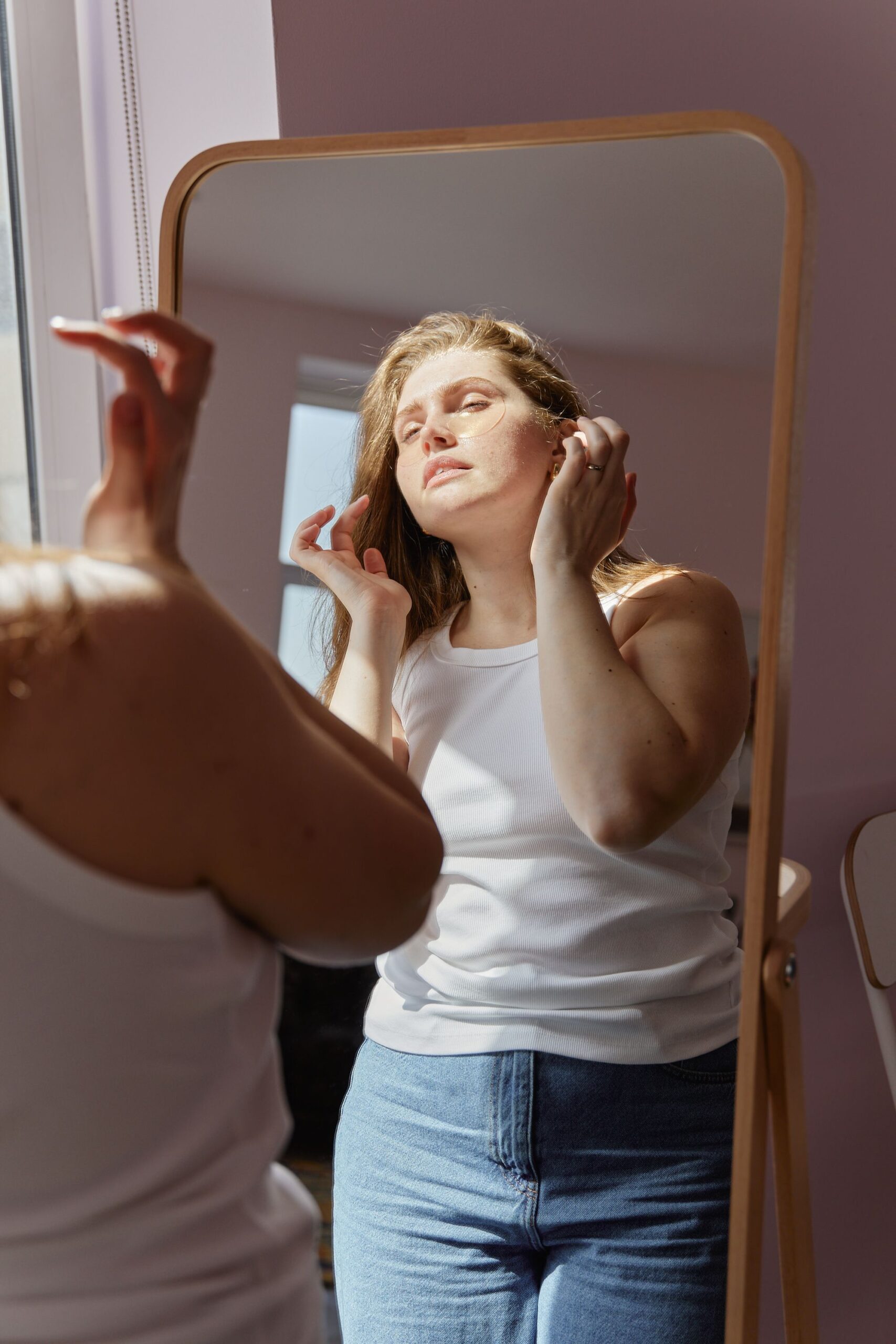 Woman with scar looking in the mirror